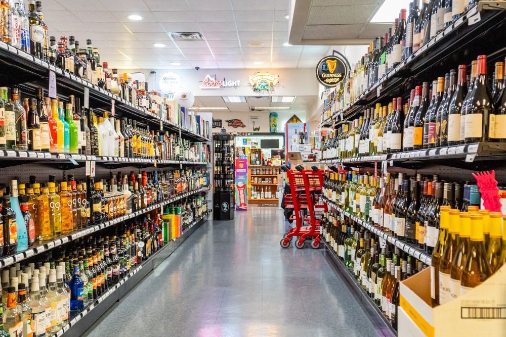 Interior aisle at Bella Vista Wine & Spirits showing wine and spirits selection.